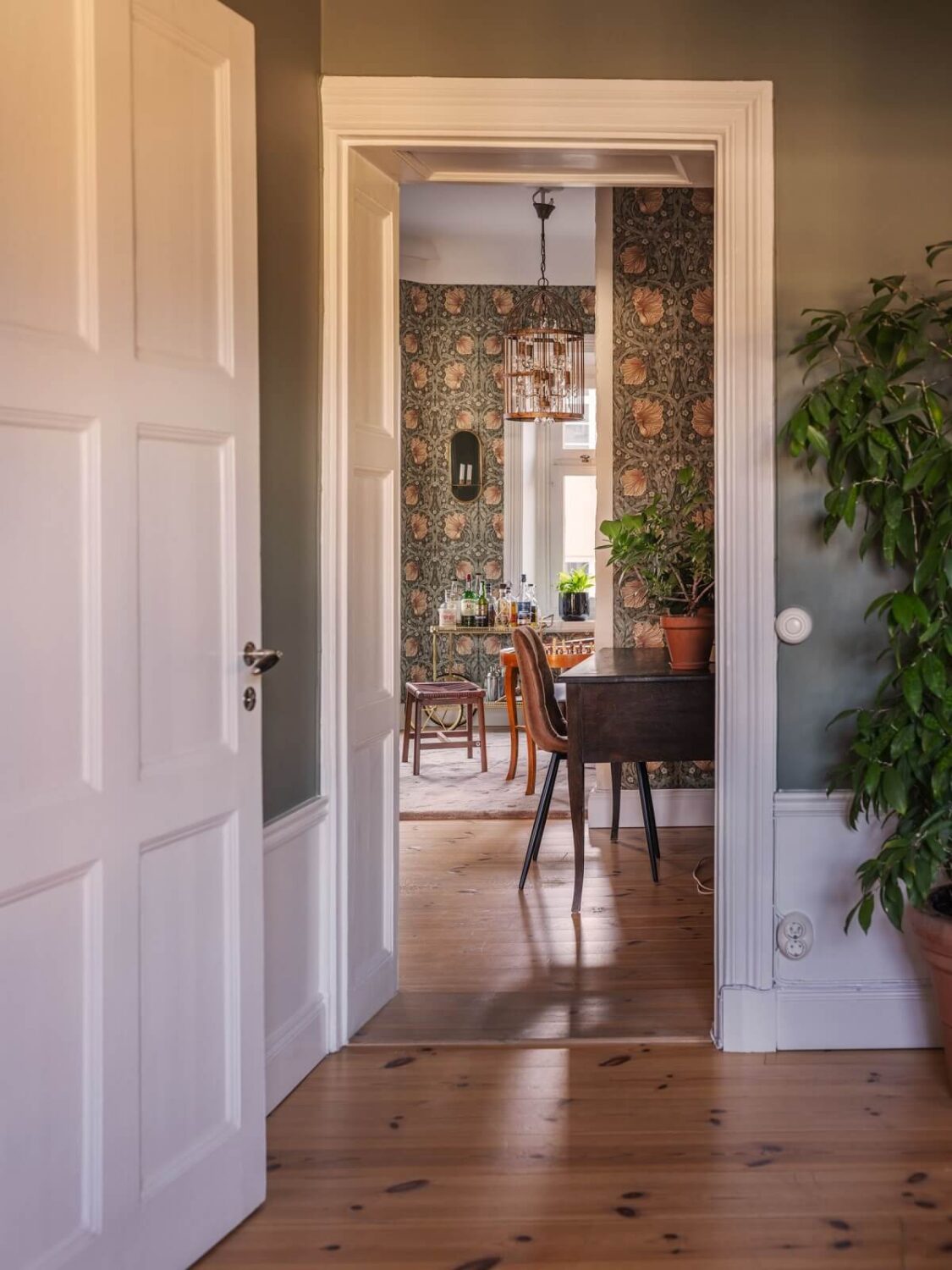 A Classic Swedish Apartment Decorated in Green and Pink Tones 10 wooden floor and home office