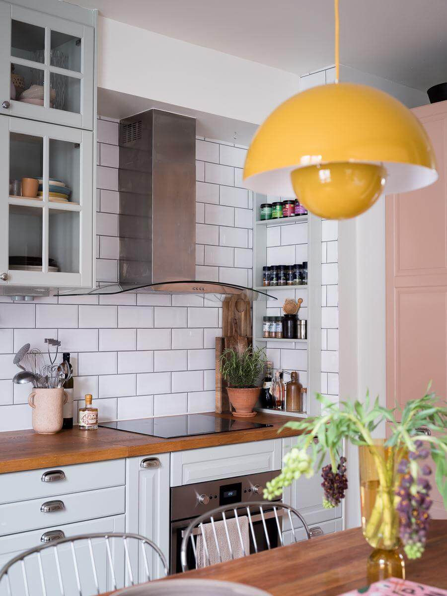 A Beautiful Color Palette in a Scandinavian Family Apartment 6 yellow flowerpot pendant light