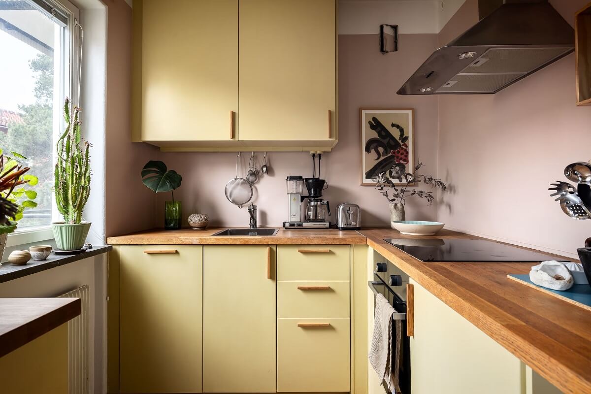 A Cozy Studio Apartment with a Yellow Kitchen 15 yellow kitchen with wooden worktop