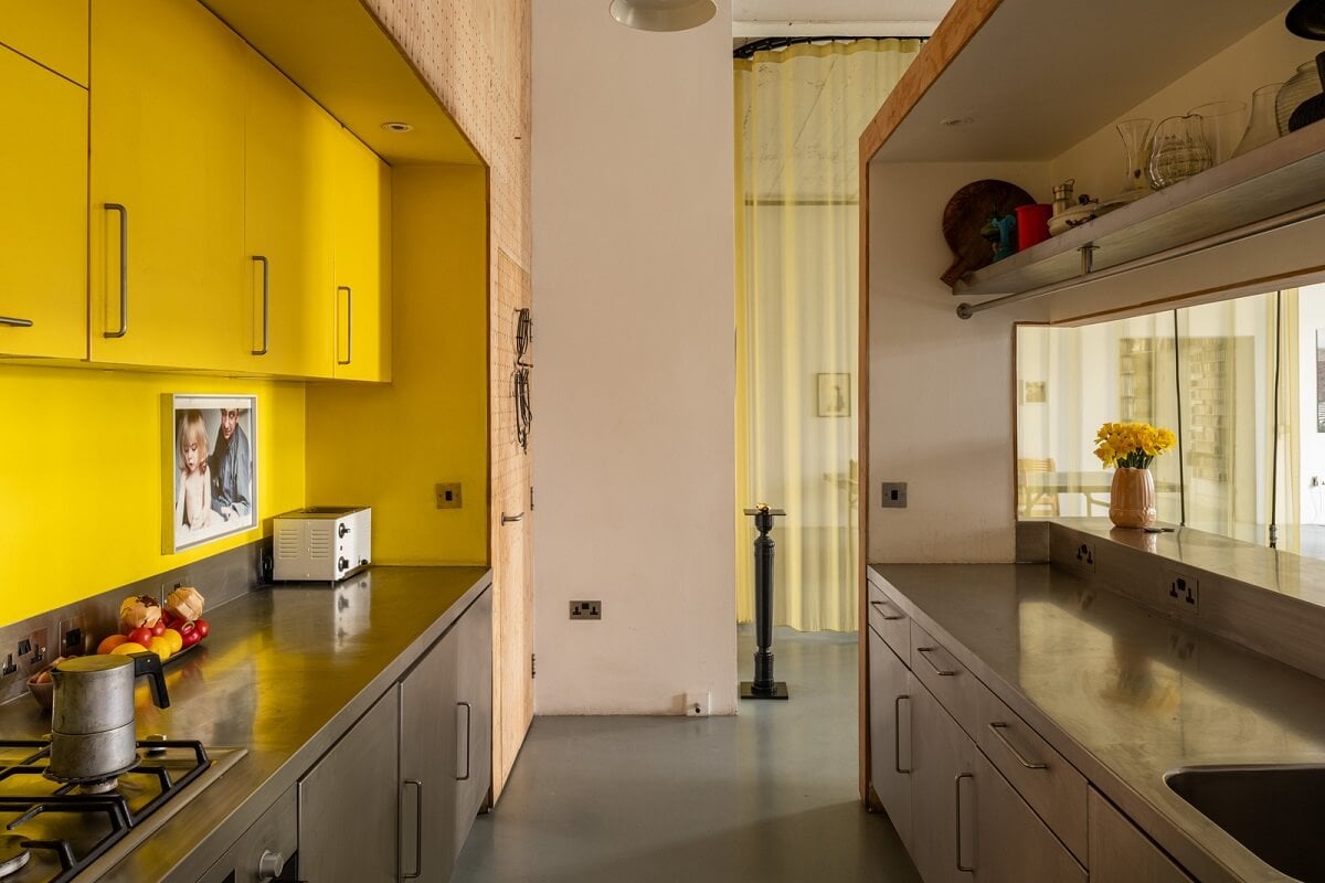 An Industrial English Loft with Yellow Color Pops 11 yellow upper cabinets