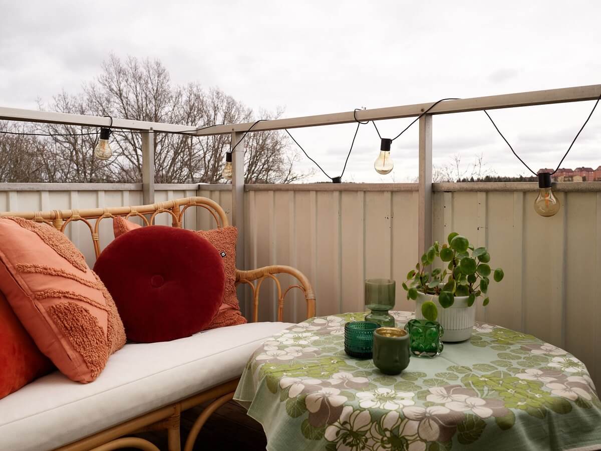 Revisiting a Small Green and Pink Midcentury Apartment 13 balcony with rattan bench Revisiting a Small Green and Pink Midcentury Apartment