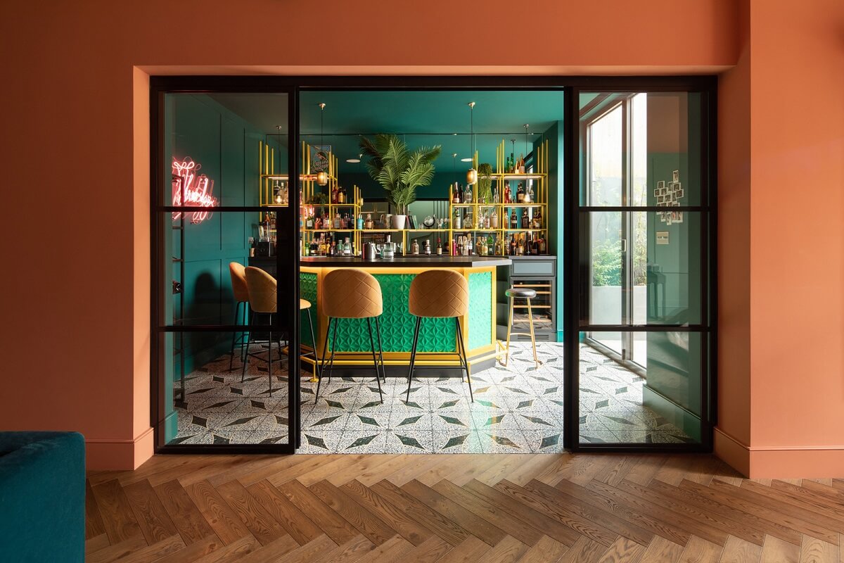 A Colorful London Family Home Renovated by Fraher & Finlay 17 basement bar with terracotta wall and green ceiling