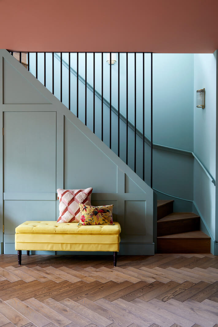 A Colorful London Family Home Renovated by Fraher & Finlay 20 basement living room with blue staircase