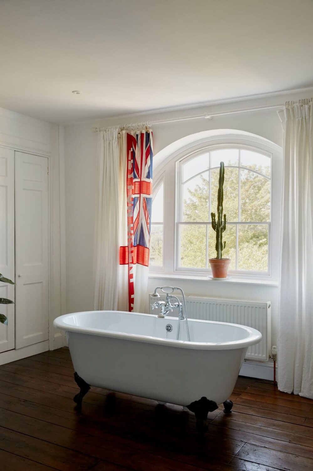 A Georgian House in England with a Ballroom 22 bathroom with clawfoot bath under window