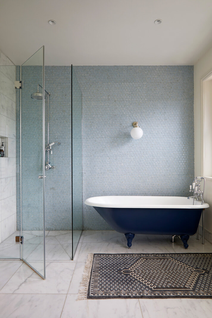 A Colorful London Family Home Renovated by Fraher & Finlay 28 bathroom with light blue wall and blue bath