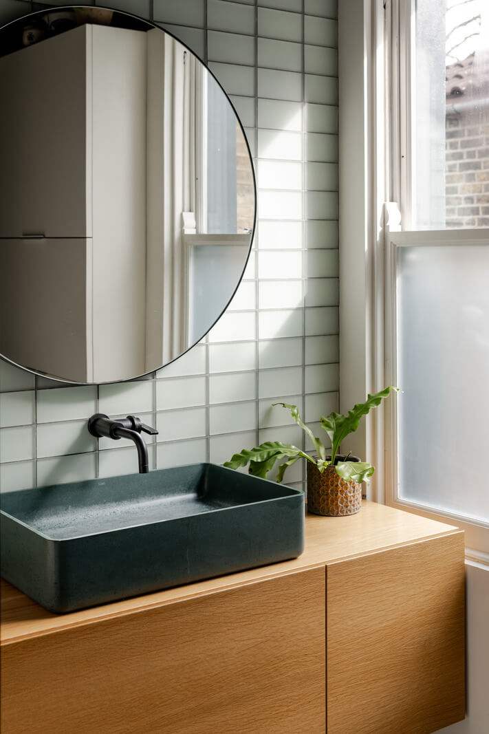 A Light London Family House with a Modern Extension 15 bathroom with round mirror