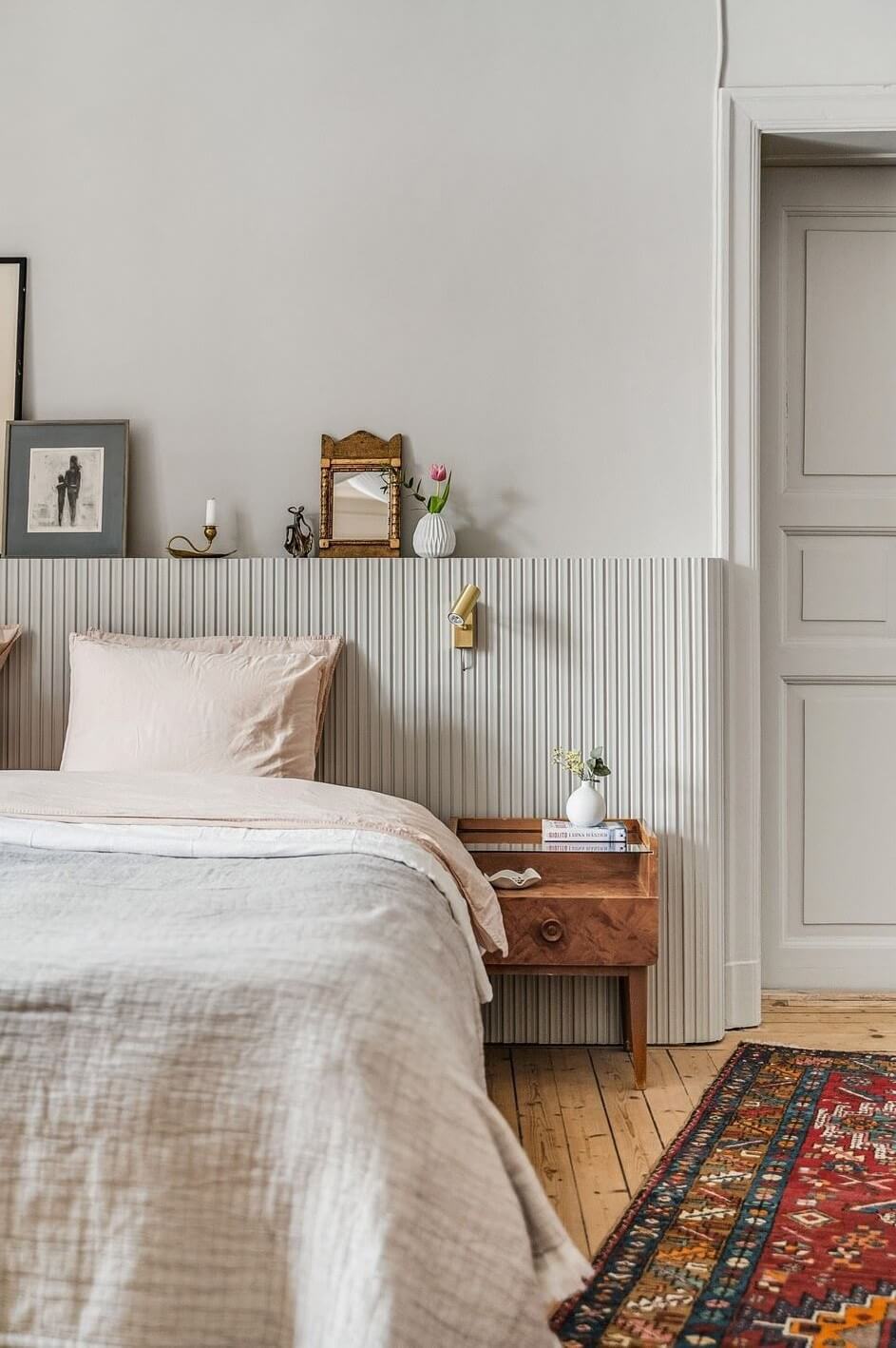 A Swedish Family Apartment with a Butter Yellow Kitchen 14 bedroom with custom headboard with ledge