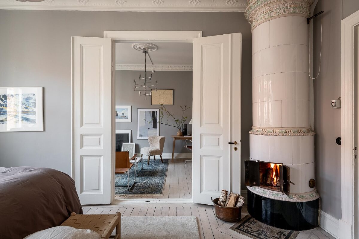 A Stylish Light Gray Swedish Apartment 15 bedroom with fireplace and double doors to living room