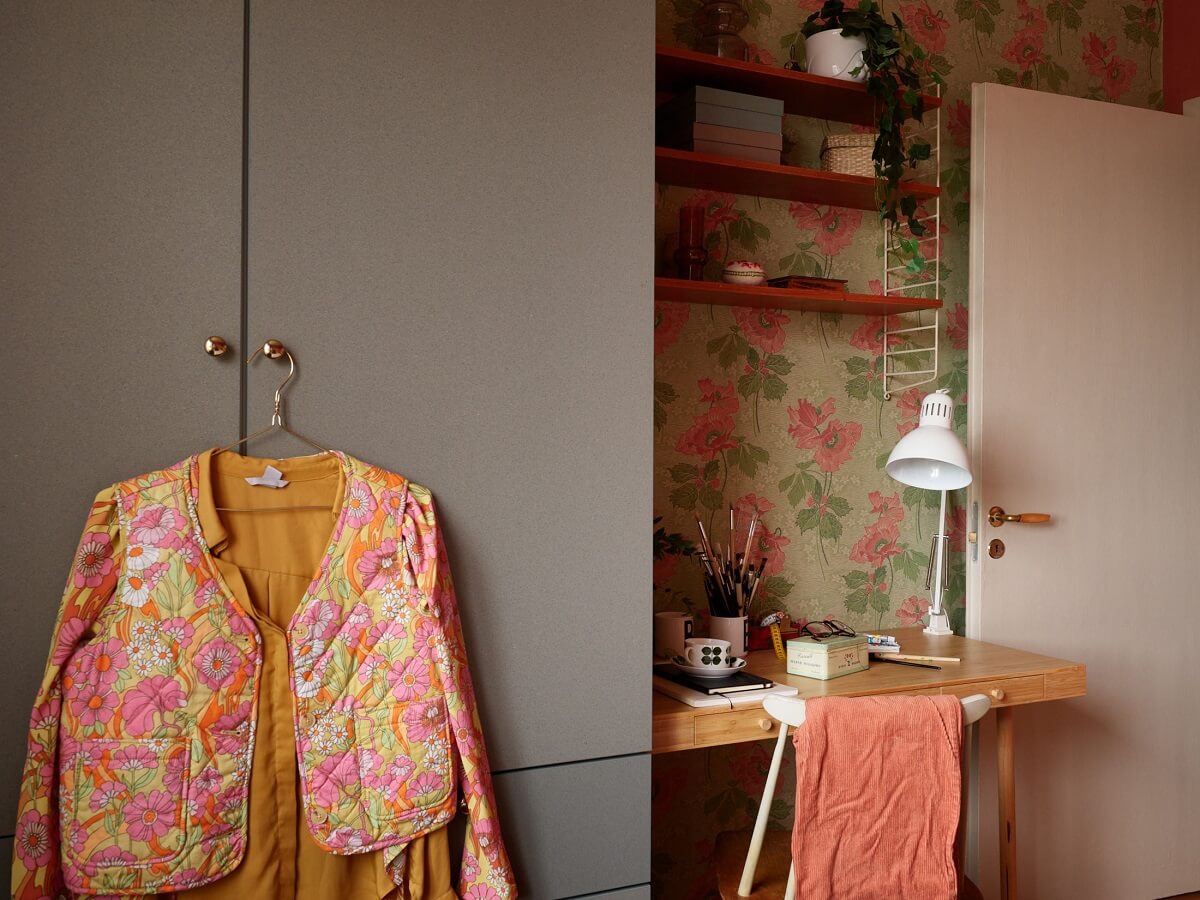 Revisiting a Small Green and Pink Midcentury Apartment 20 bedroom with floral wallpaper and ikea desk