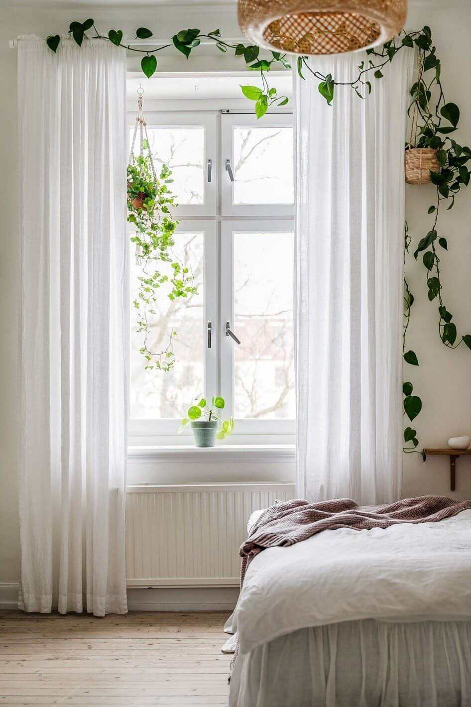 A Swedish Family Apartment with a Butter Yellow Kitchen 18 bedroom with plants around the window