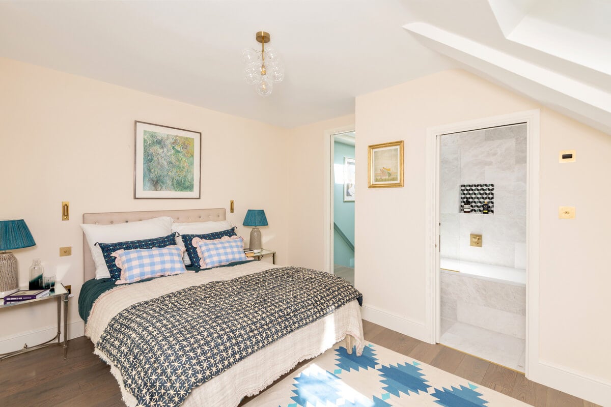 A Light London Maisonette in a Former Artist's Studio 18 bedroom with slanted ceiling and blue color accents