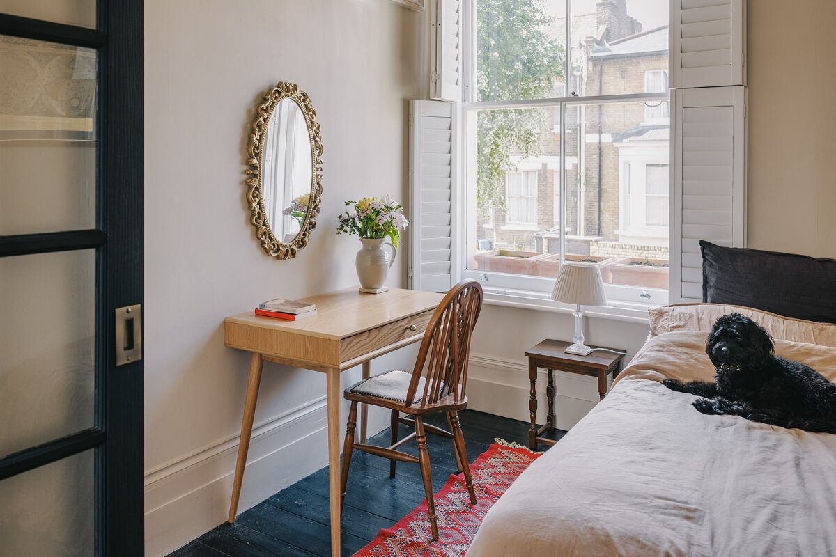 A Small London Apartment Filled with Books 12 beige bedroom with desk and dark wooden floor
