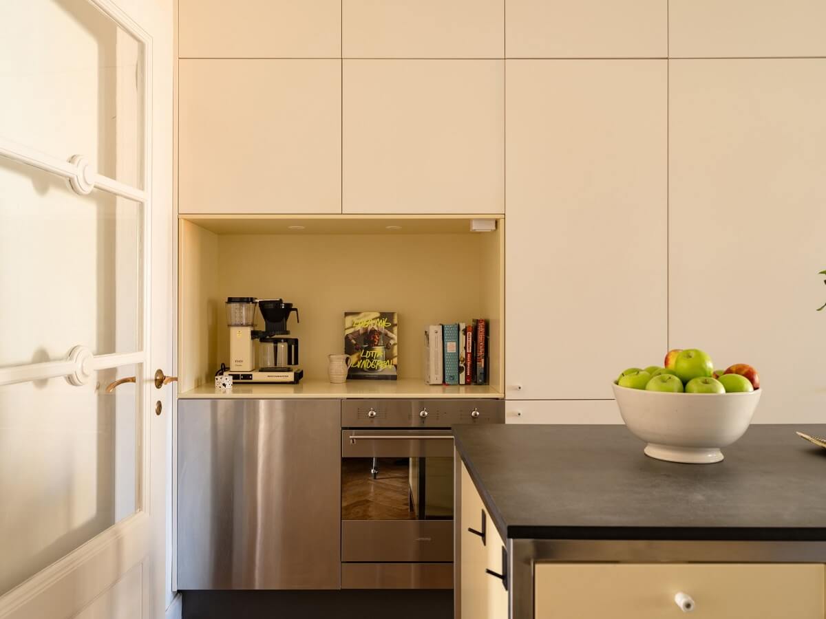 A Stockholm Apartment with Bright Green Color Accents 10 beige kitchen with island