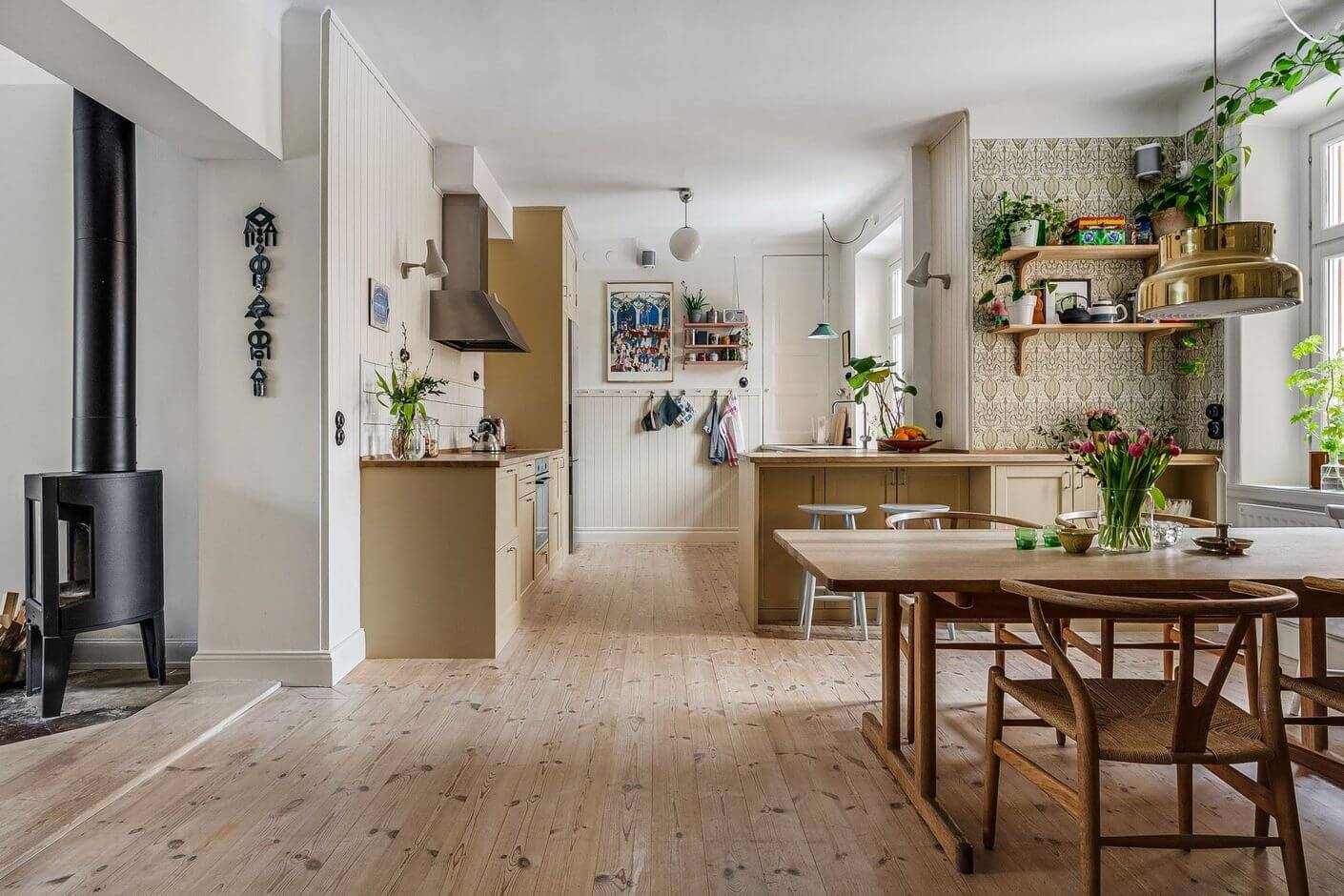 A Swedish Family Apartment with a Butter Yellow Kitchen 2 big kitchen and dining room with wallpaper