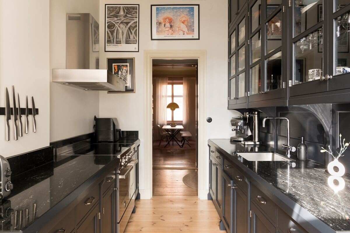 A Pink Apartment with a Black Kitchen 17 black galley kitchen with closed and glass cabinets nordroom