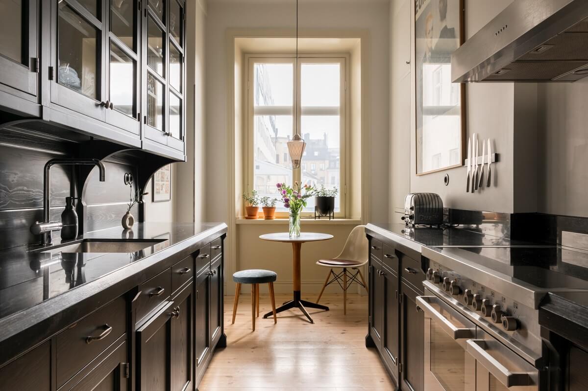 A Pink Apartment with a Black Kitchen 13 black kitchen with smal breakfast table nordroom