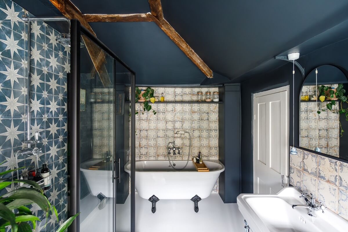 A Charming English Cottage Filled with Historic Character 16 blue bathroom with clawfoot bath and ceiling beams