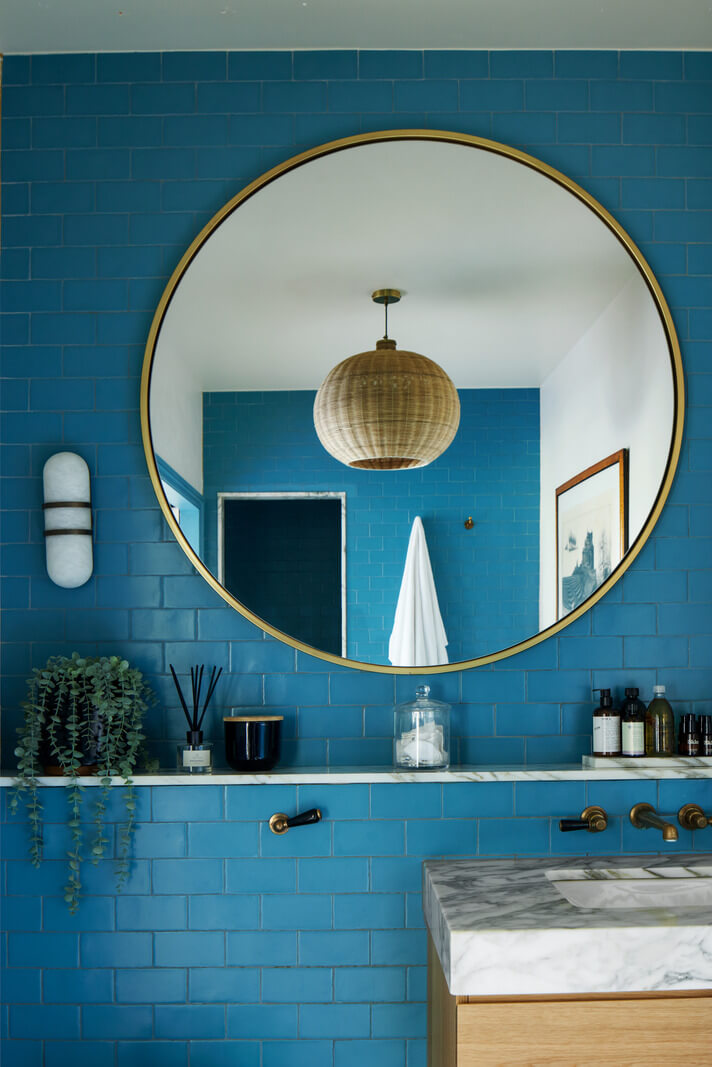 Historic Features and Modern Design in an English Regency Villa 16 blue bathroom with large round mirror
