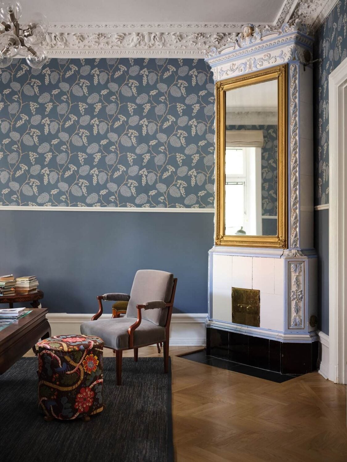 A Classic Stockholm Apartment with Floral Wallpaper 4 blue living room with floral wallpaper fireplace with gilded mirror nordroom