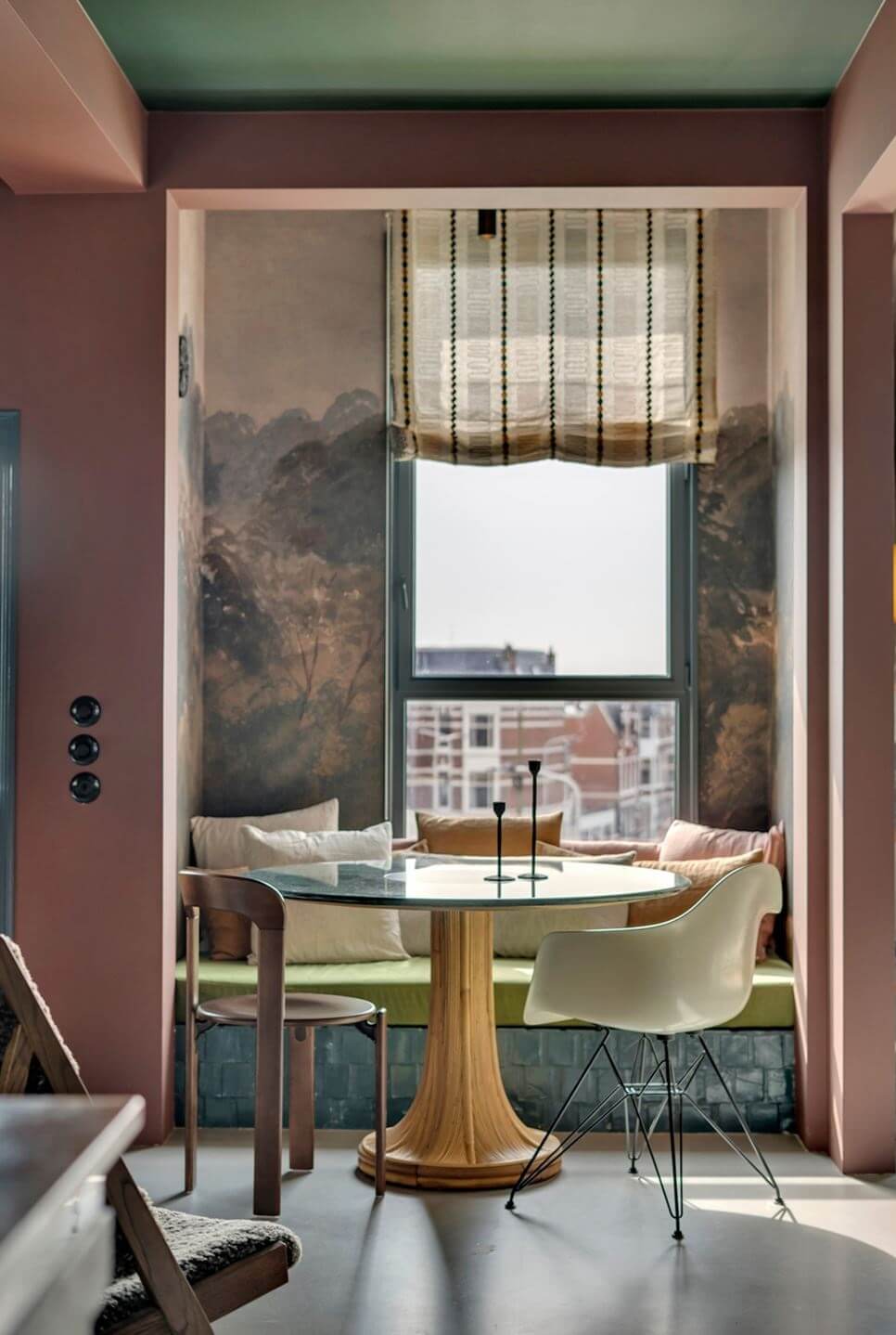 Color and Graphic Design in the Home of a Dutch Interior Stylist 18 breakfast nook with round table and window bench