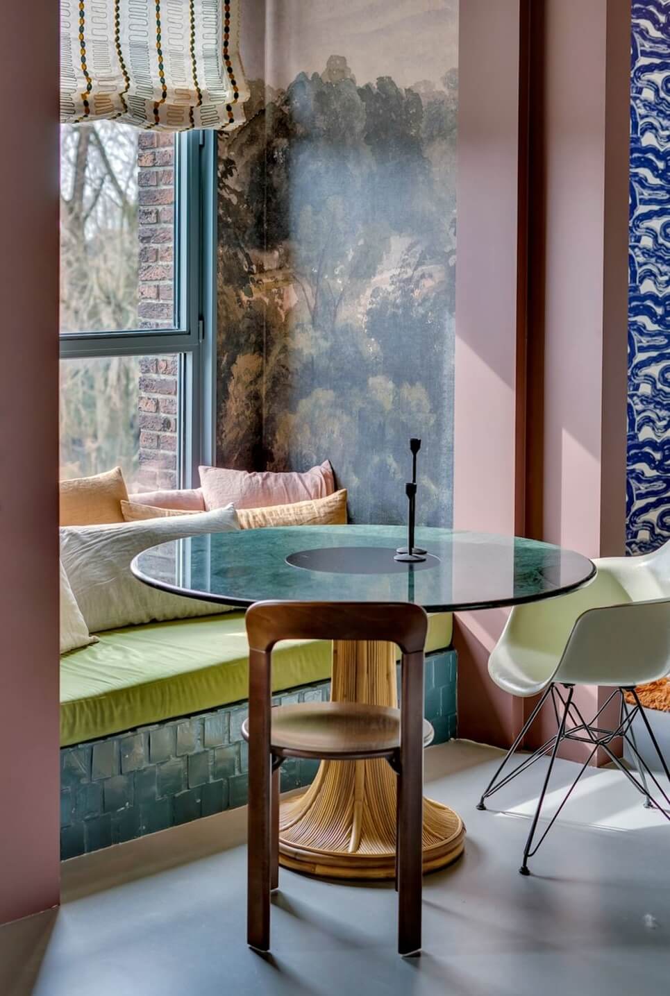 Color and Graphic Design in the Home of a Dutch Interior Stylist 17 breakfast nook with wallpaper round table and window bench