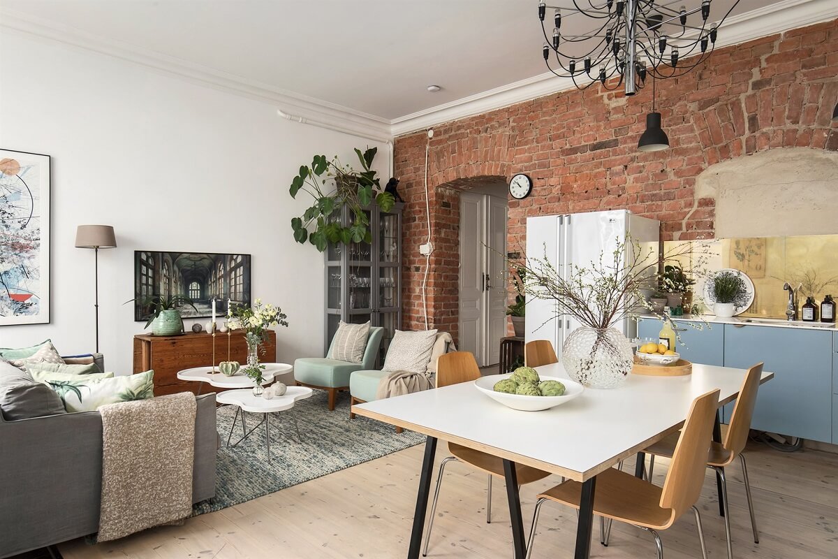 A Swedish Apartment with an Exposed Brick Wall 3 brick feature wall scandi living room