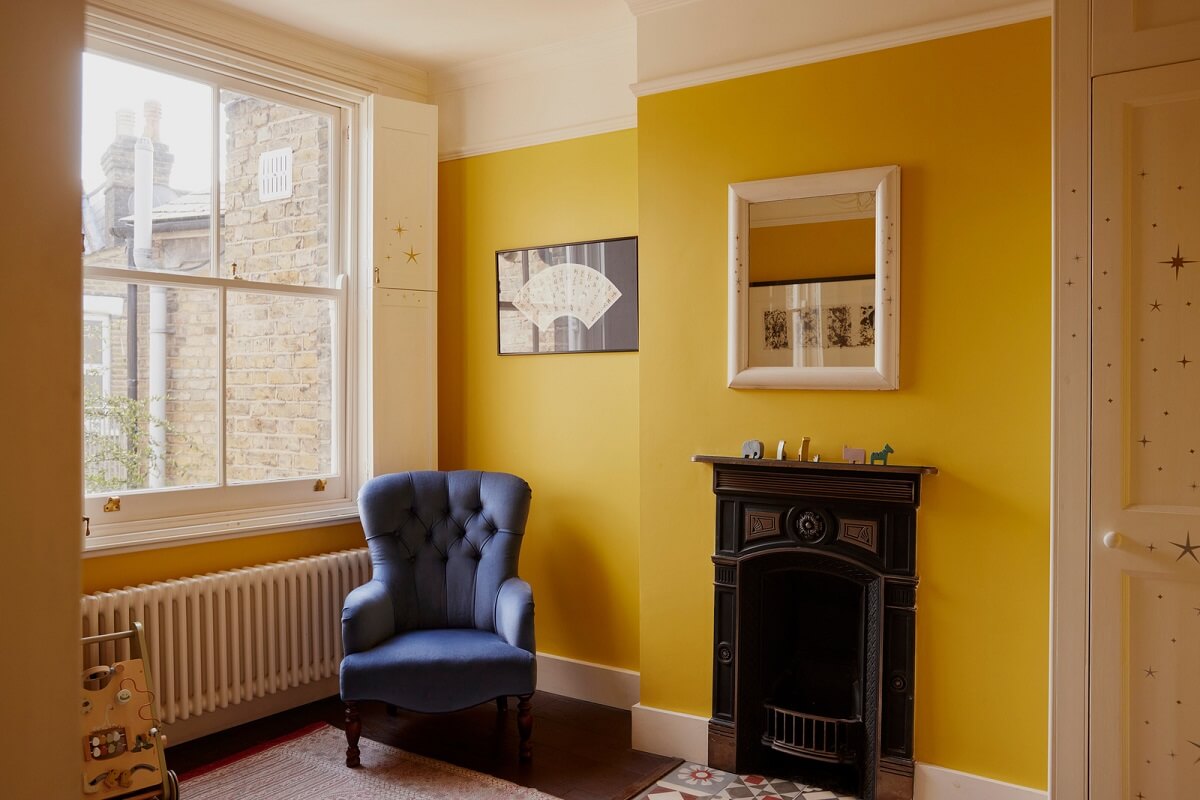 A London Maisonette with A Light Blue deVOL Kitchen 11 bright yellow children bedroom with black fireplace