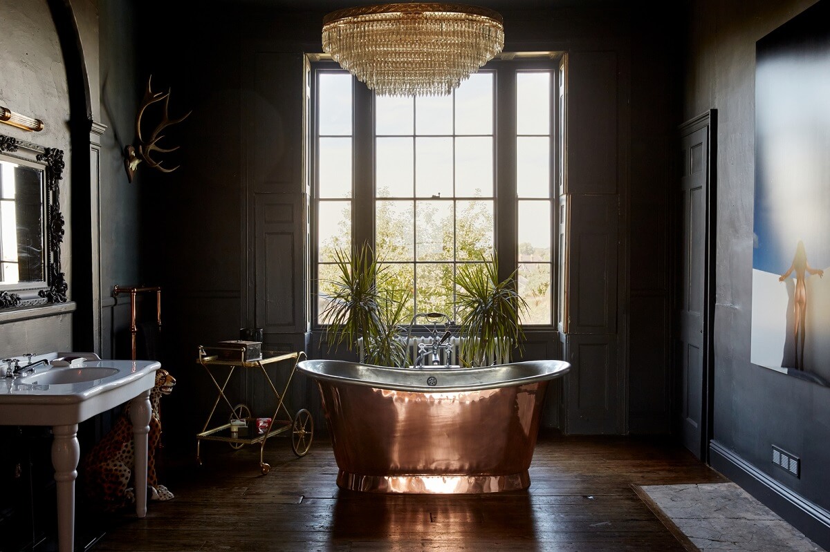A Georgian House in England with a Ballroom 16 dark gray bathroom with copper bath