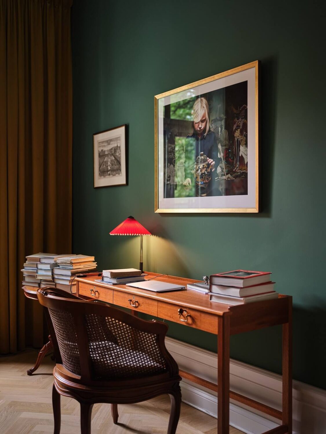A Classic Stockholm Apartment with Floral Wallpaper 8 dark green home office with vintage desk nordroom
