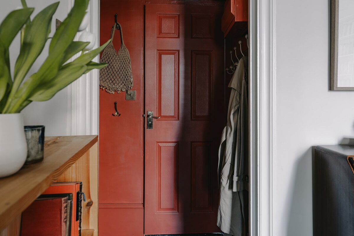 A Small London Apartment Filled with Books 14 deep red hallway