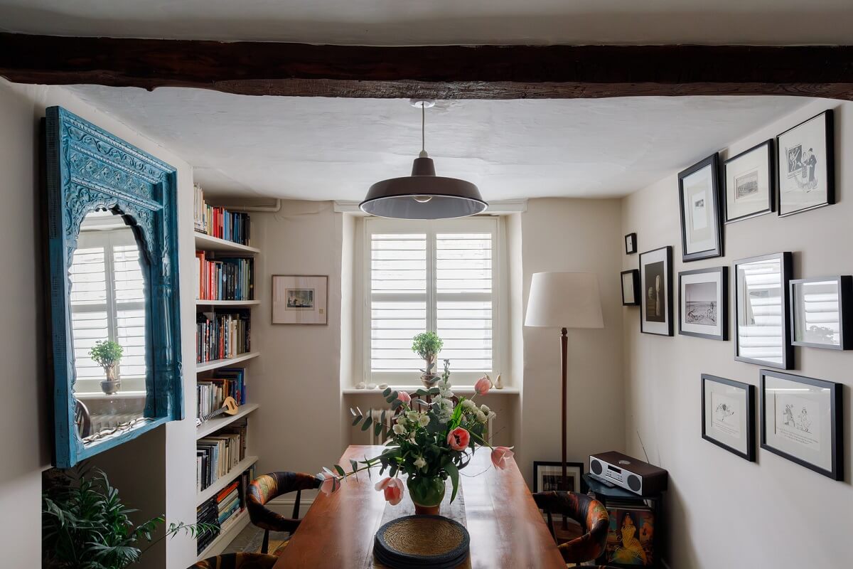 A Charming English Cottage Filled with Historic Character 6 dining room with bookshelves