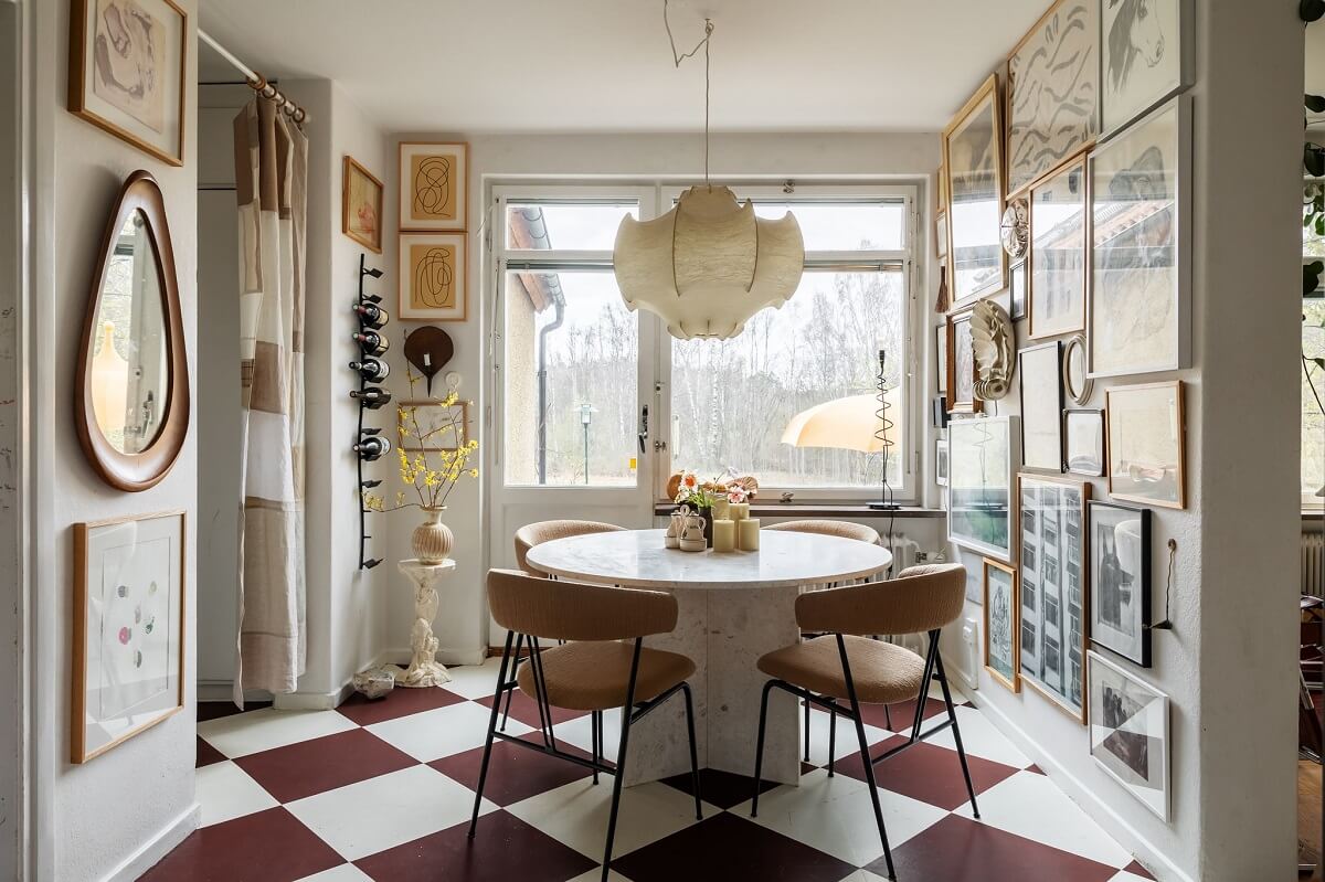 A Swedish Family House with Wall Murals and Art 7 dining room with gallery wall and checkerboard floor