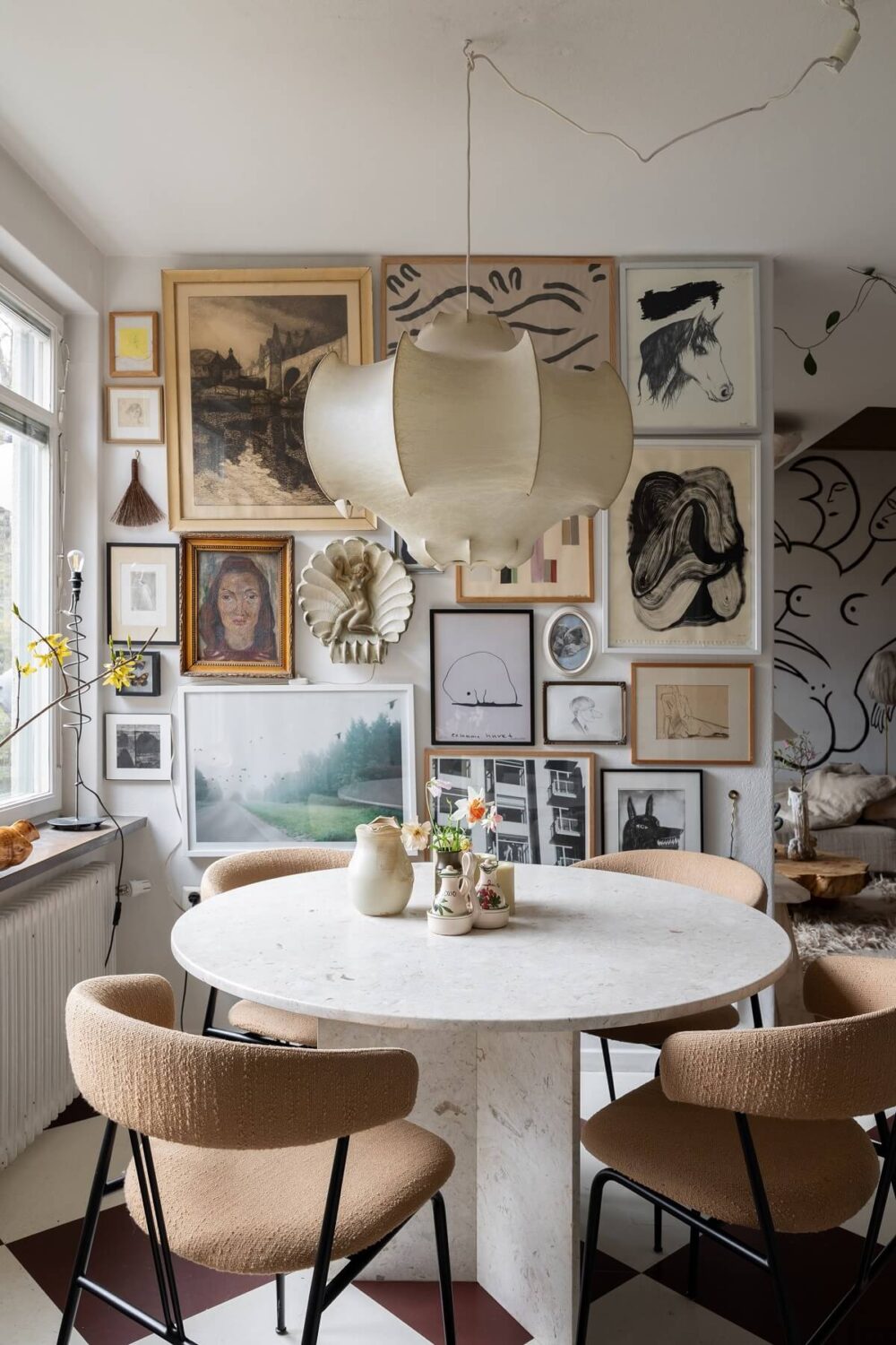 A Swedish Family House with Wall Murals and Art 8 dining room with round table and gallery wall