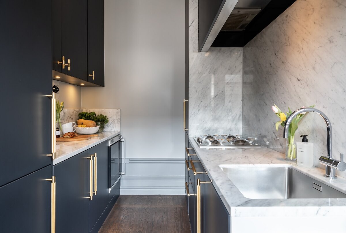A Classic Swedish Apartment with a Dark Blue Bedroom 8 galley kitchen ith dark blue cupboards