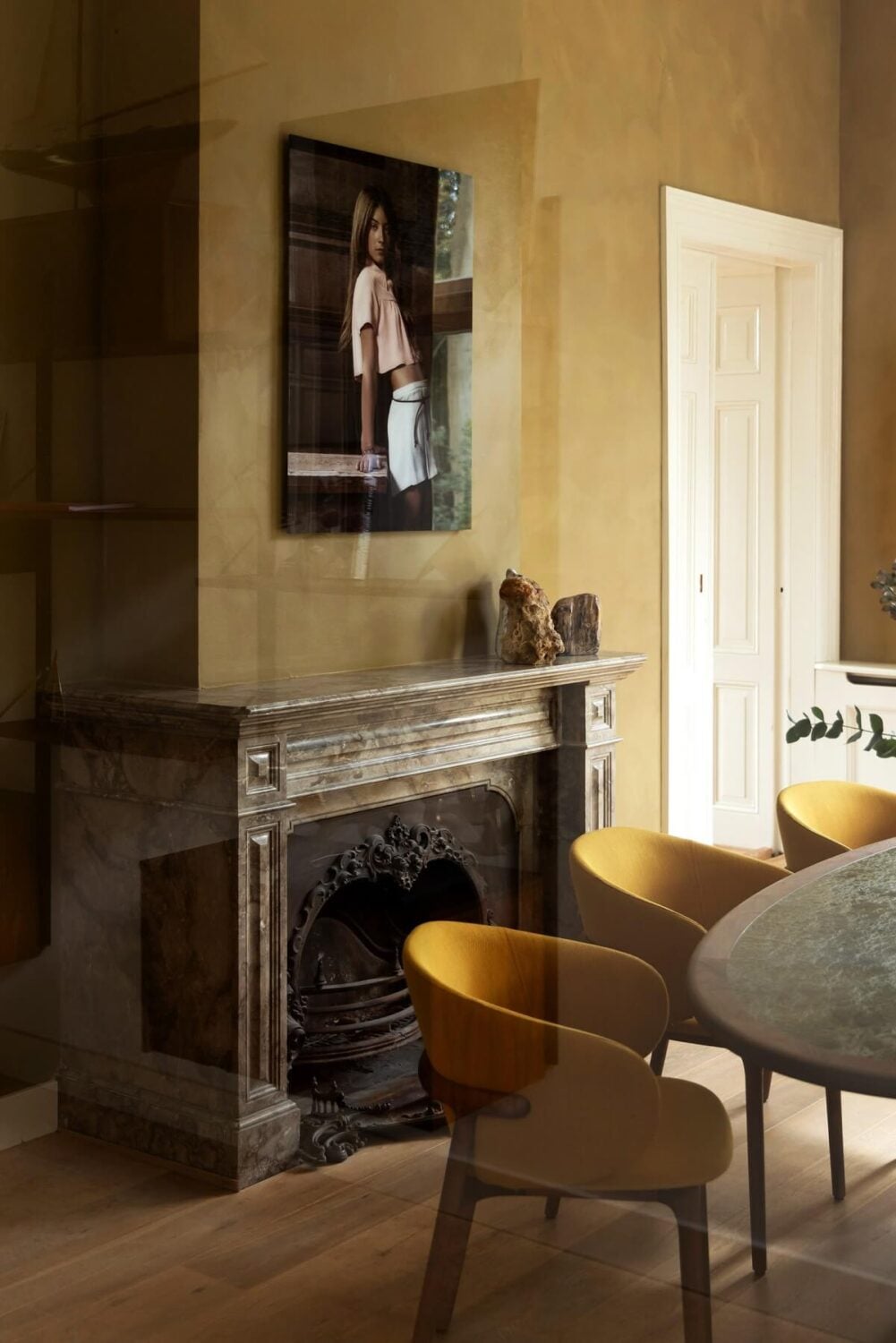 A Warm Atmosphere in a Historic Dutch Villa 5 golden yellow dining room with fireplace
