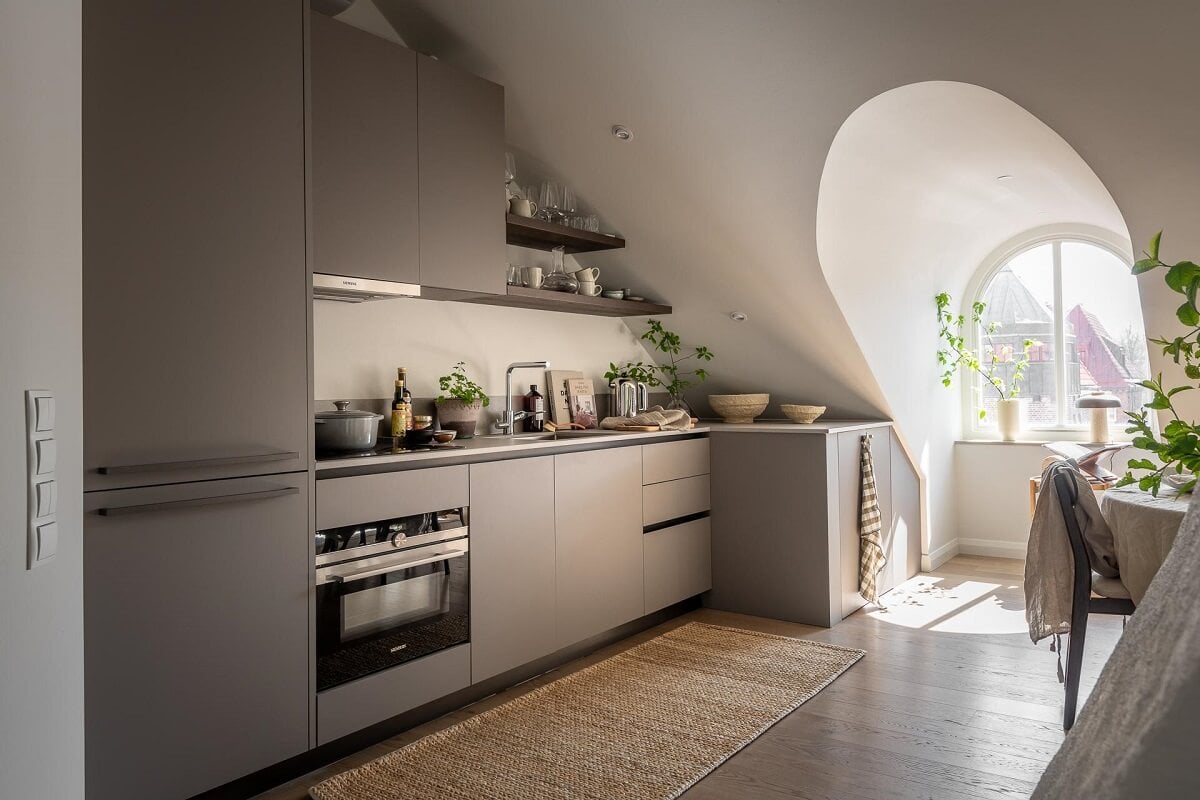 An Attic Studio Apartment with a Glass Room Divider 14 gray minimalistic kitchen