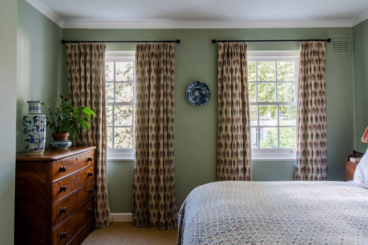 A Colorful Neo-Georgian House in London 15 green bedroom with wooden dresser