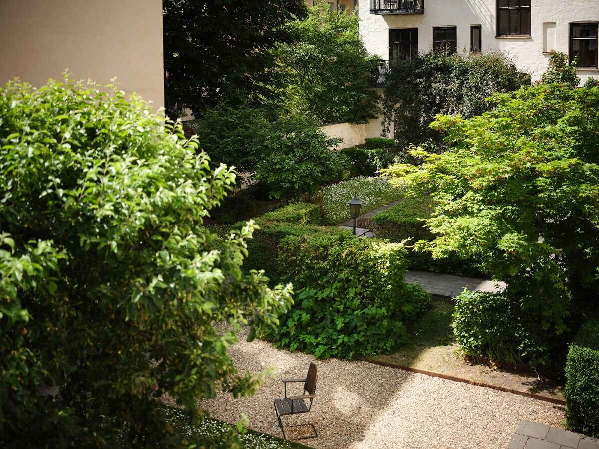 A Classic Stockholm Apartment with Floral Wallpaper 34 green courtyard