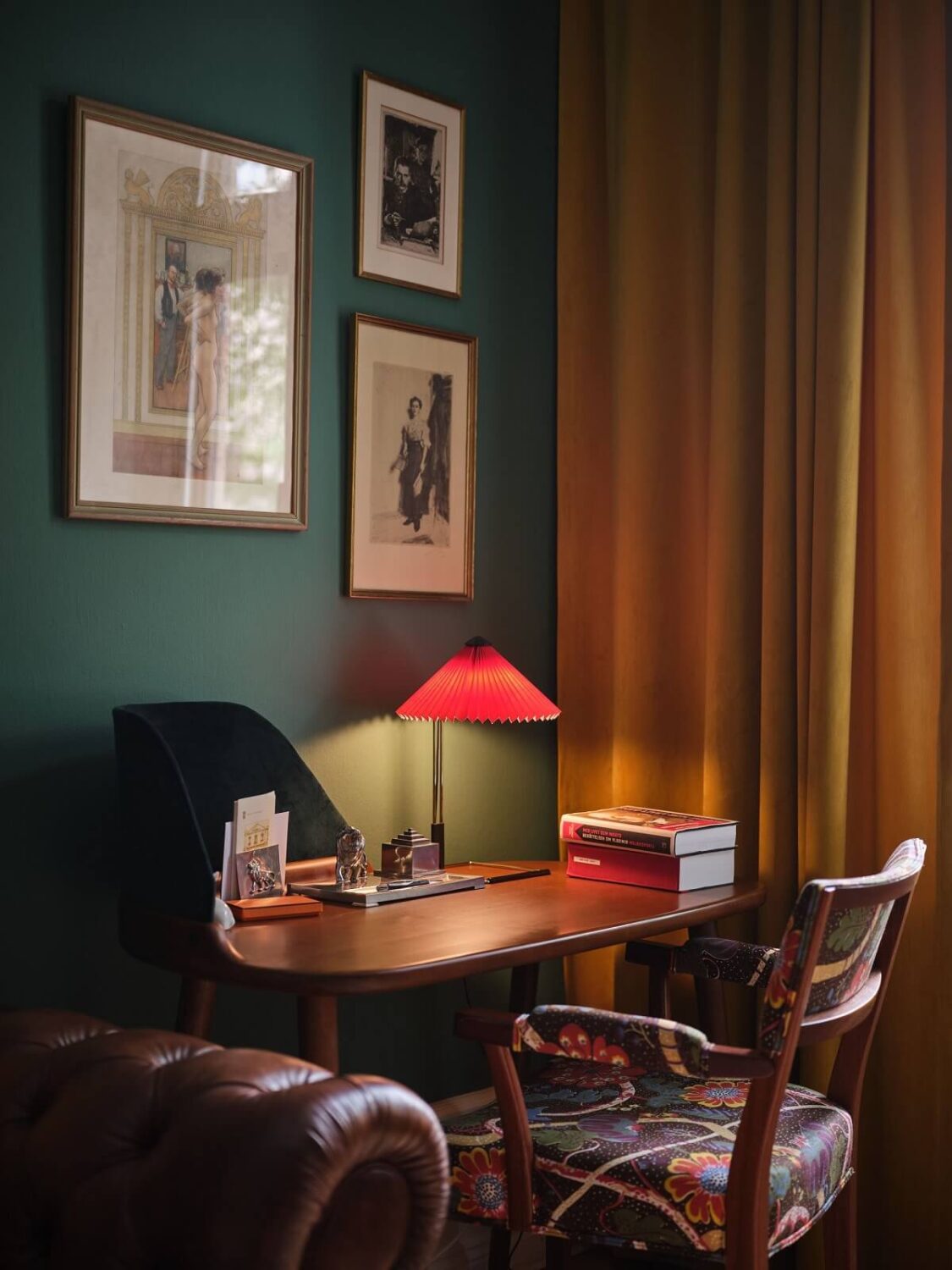 A Classic Stockholm Apartment with Floral Wallpaper 9 green home office with antique design red table lamp and ochre yellow curtains nordroom