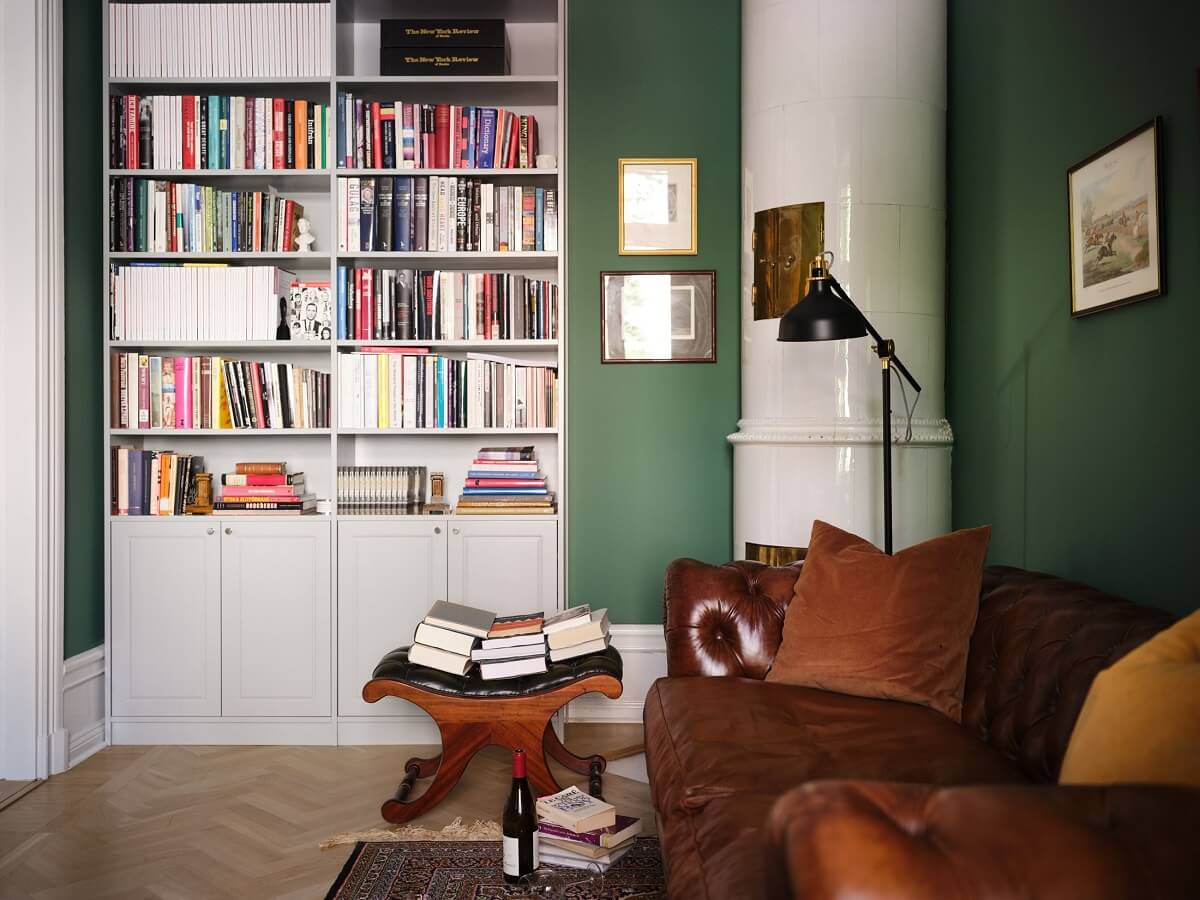 A Classic Stockholm Apartment with Floral Wallpaper 10 green home office with bookshelves nordroom