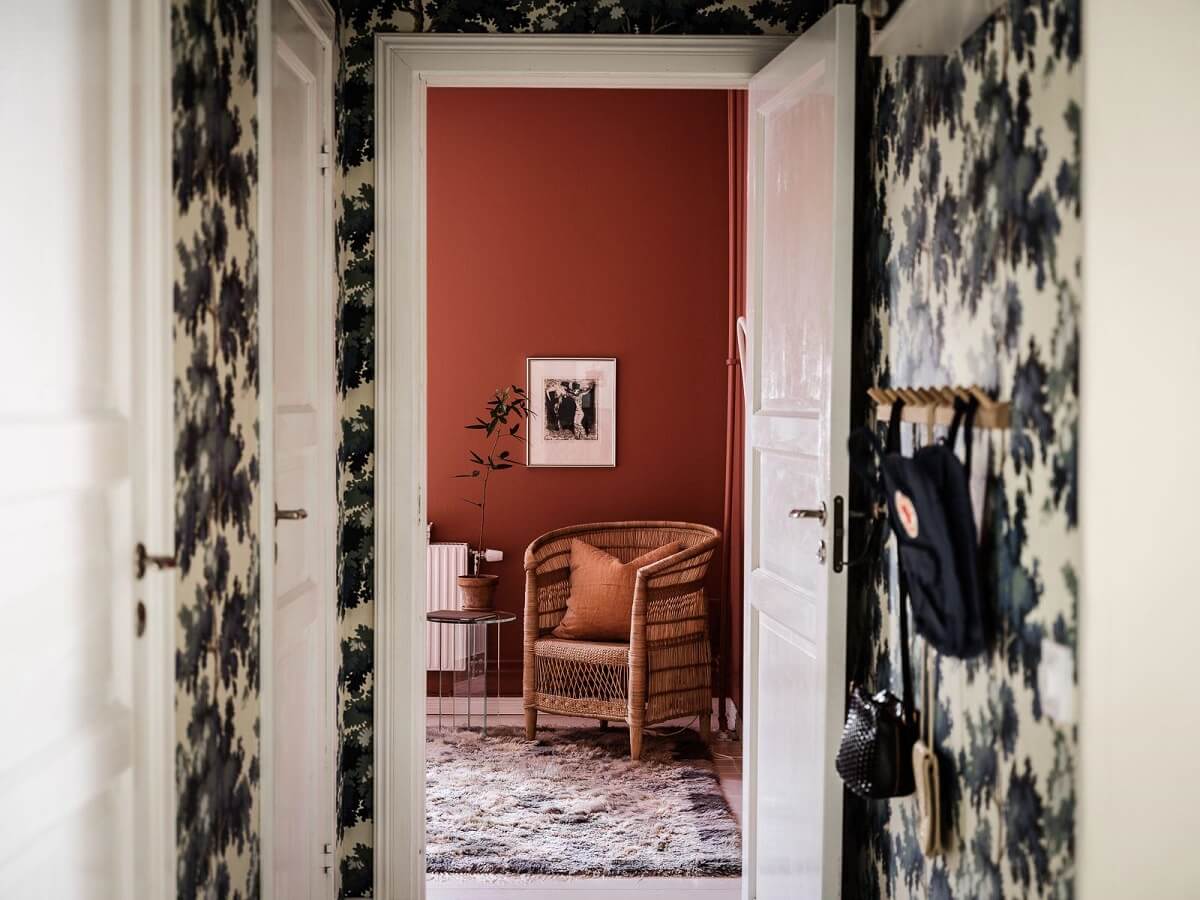 A Scandinavian Apartment with a Rust Red Bedroom 12 hall view into bedroom