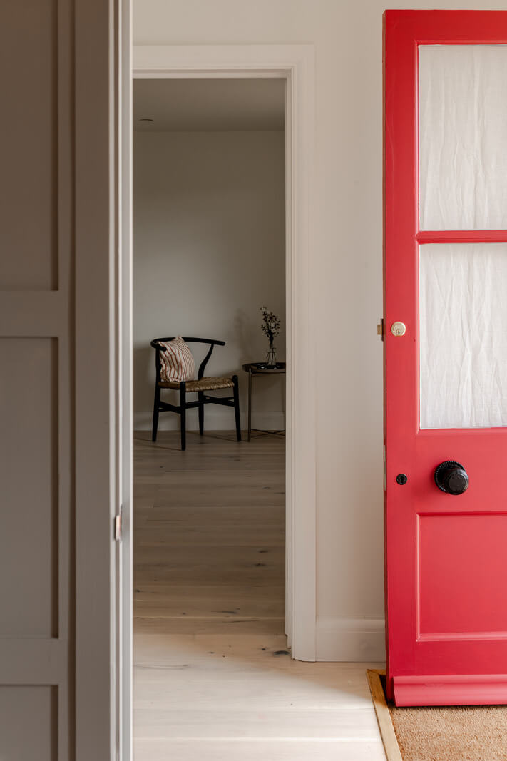 A Modern Barn House in the English Countryside 12 hallway red front door