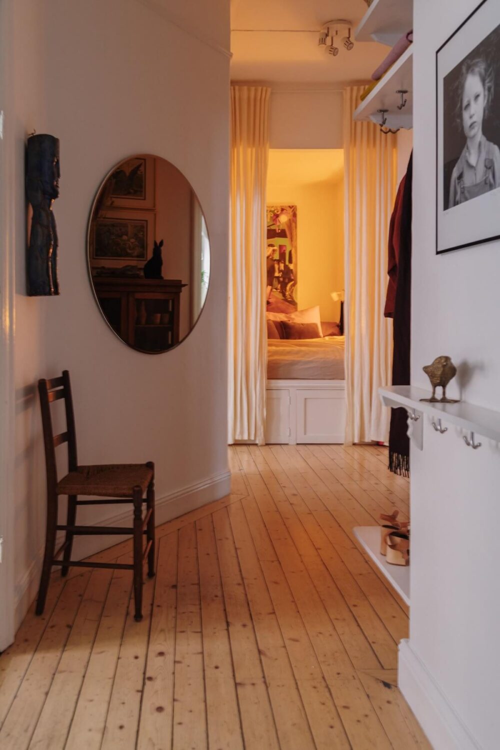 Period Details and Light Rooms in a Scandinavian Apartment 21 hallway round mirror wooden floor