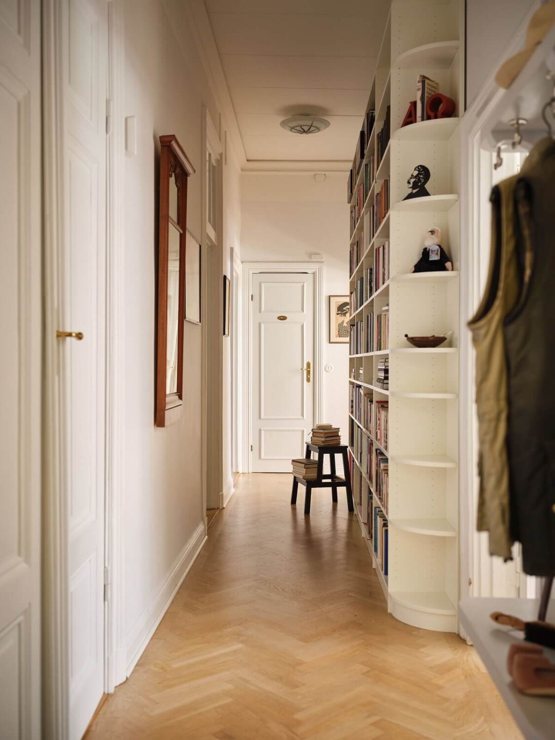 A Classic Stockholm Apartment with Floral Wallpaper 24 hallway with bookshelves