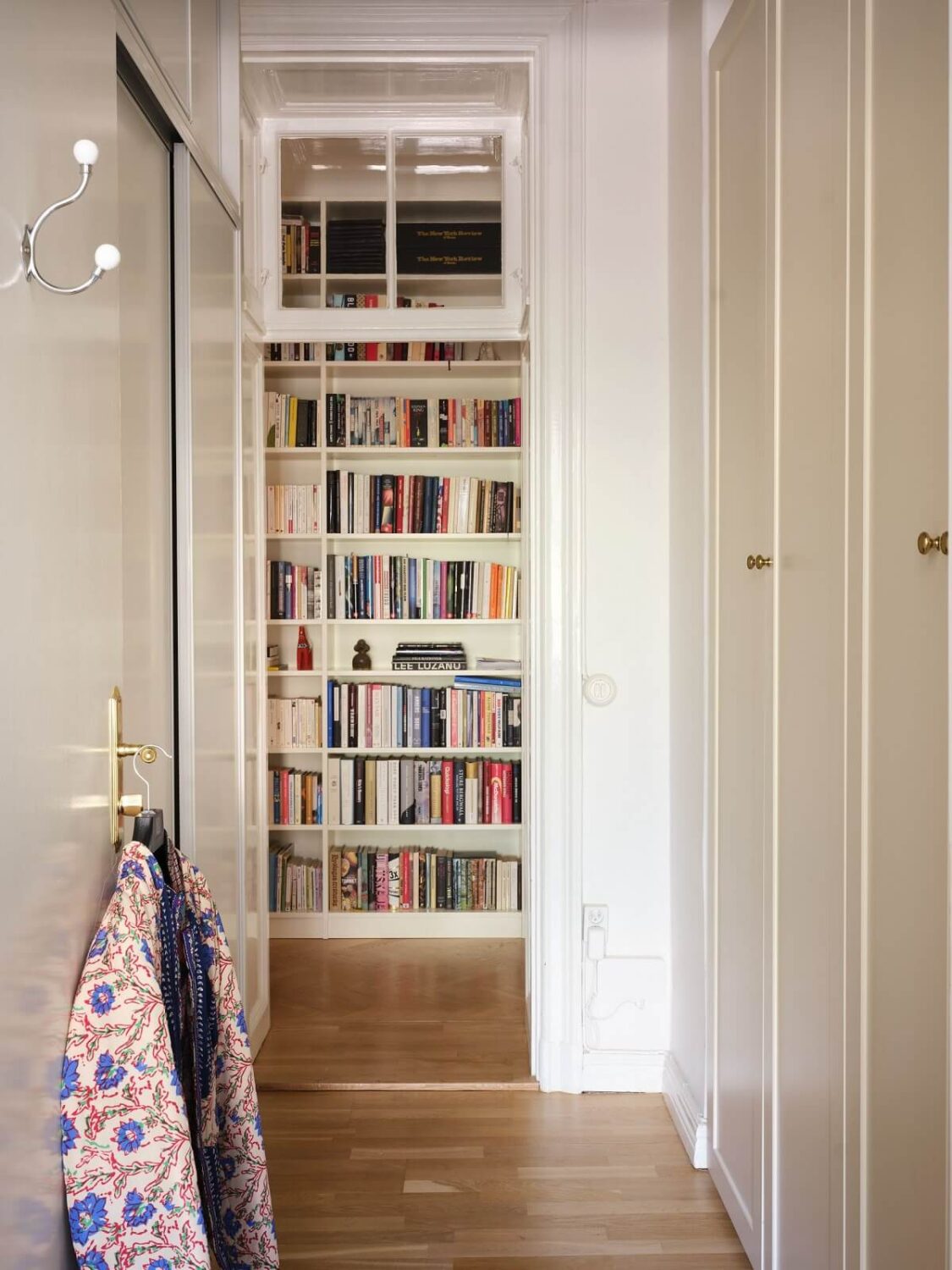 A Classic Stockholm Apartment with Floral Wallpaper 23 hallway with built in cabinets and bookshelves nordroom