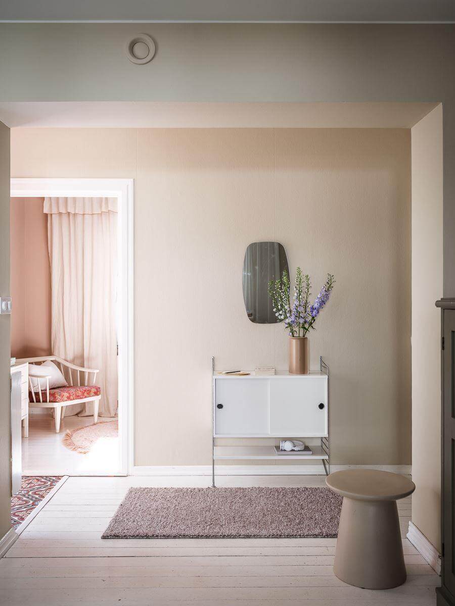 A Scandinavian Apartment with a Rust Red Bedroom 8 hallway with minimalistic cabinet