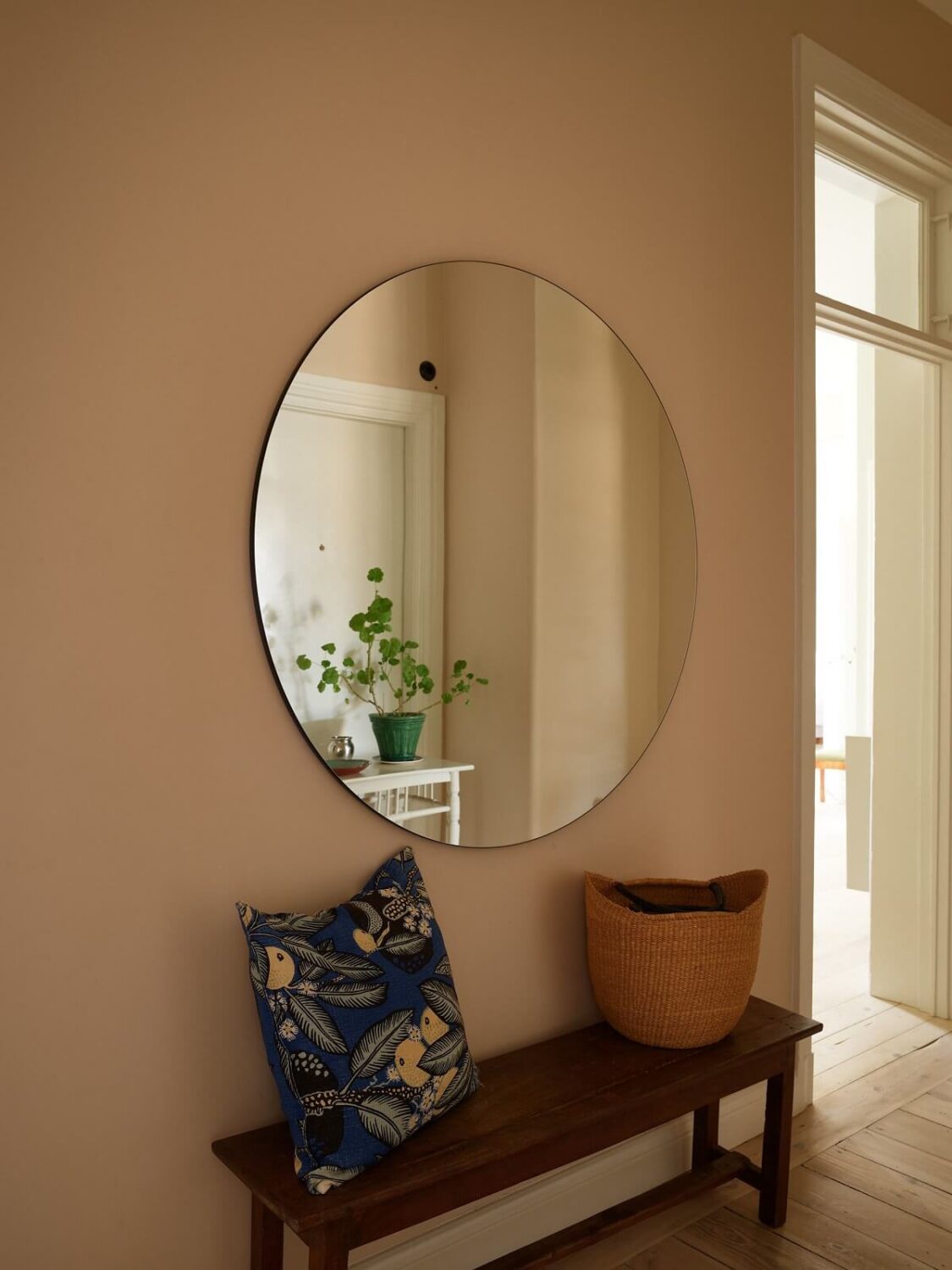 A Green Kitchen in a Gray Family Apartment 33 hallway with round mirror