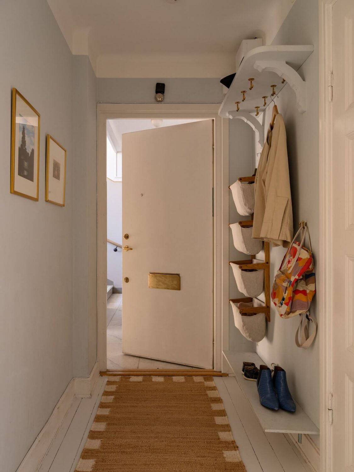 A Stockholm Apartment with Bright Green Color Accents 20 hallway with runner