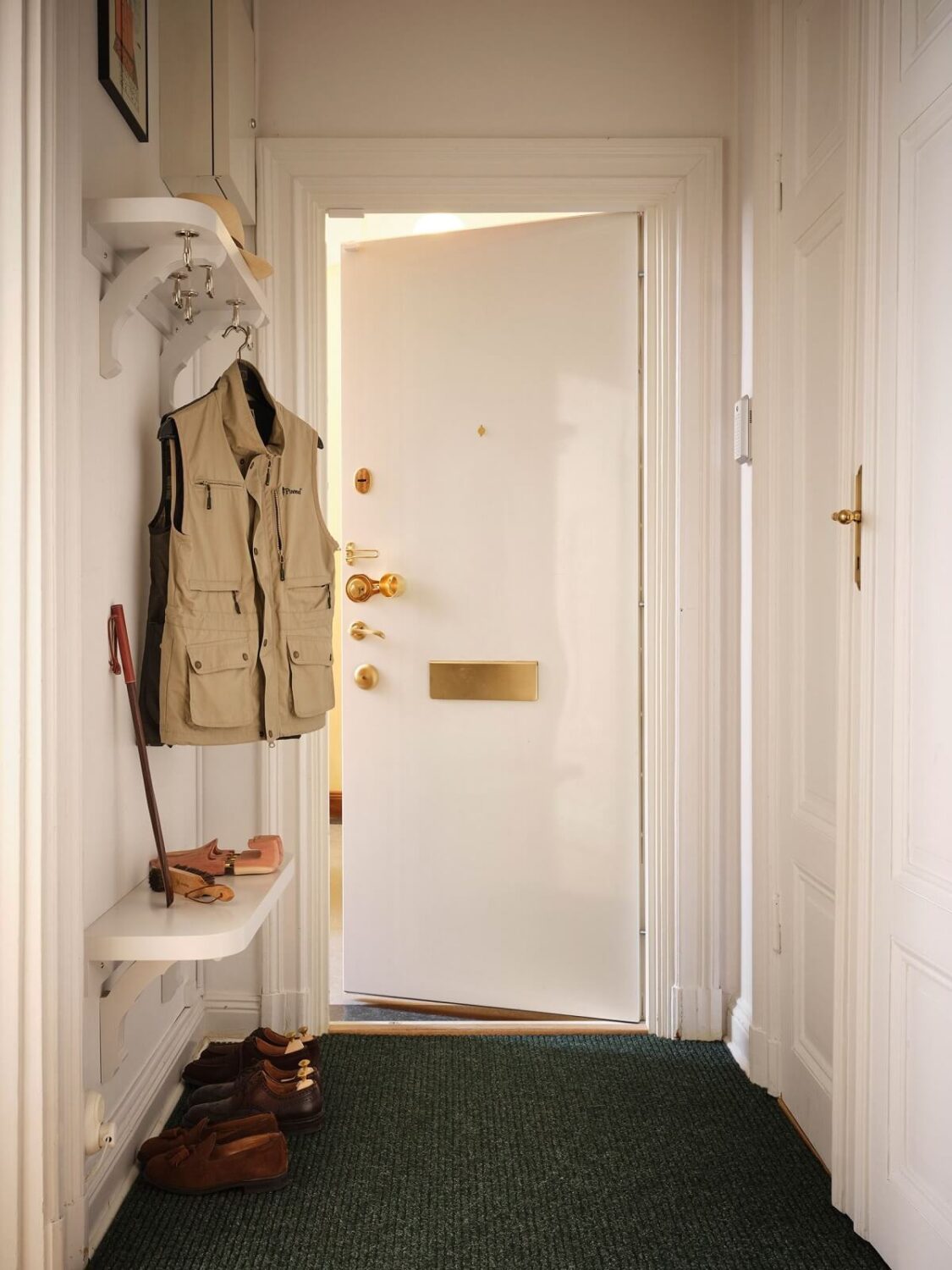 A Classic Stockholm Apartment with Floral Wallpaper 33 hallway with shelves nordroom