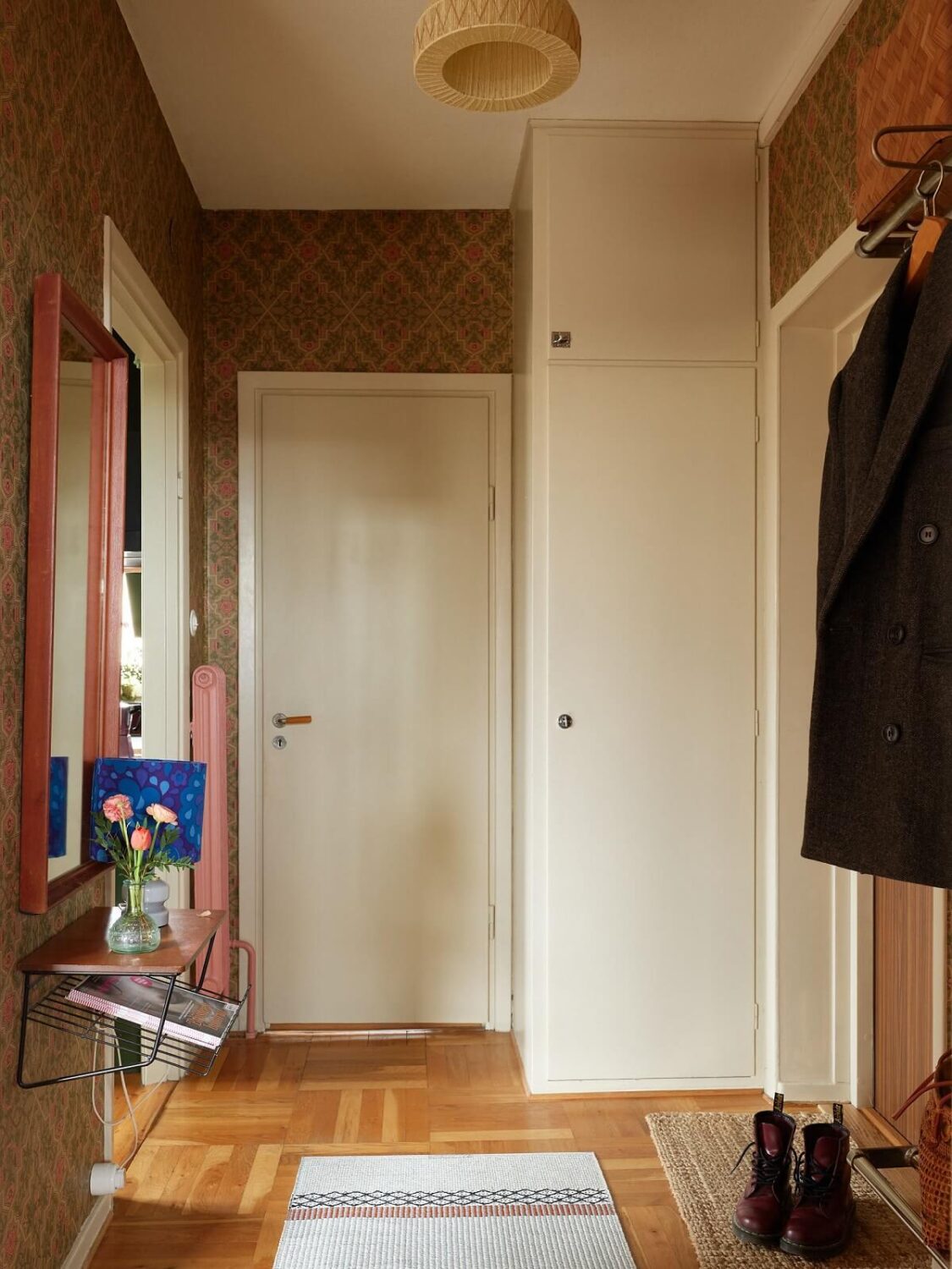 Revisiting a Small Green and Pink Midcentury Apartment 21 hallway with wallpaper